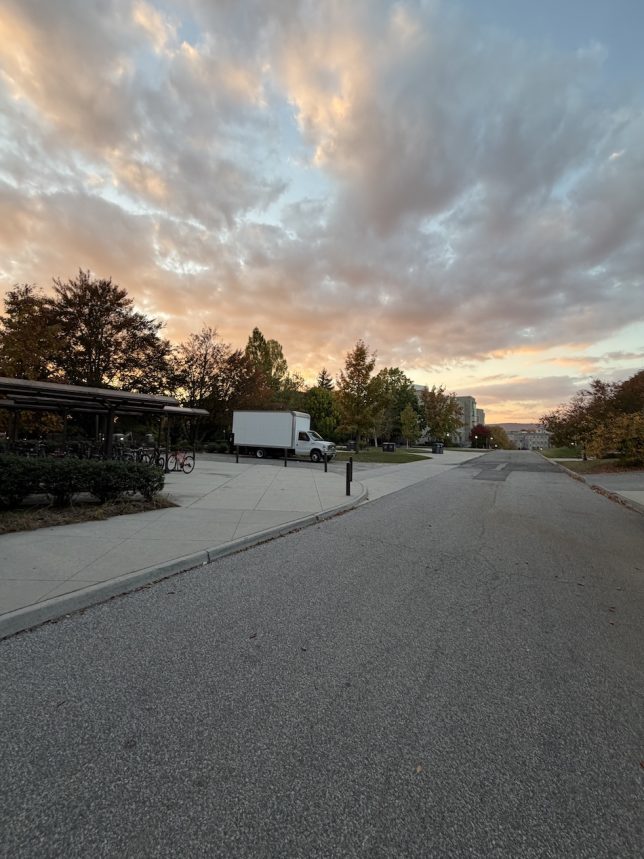 Figure 1: A picture taken just outside the North entrance of Ambler Johnston Hall during sunset, showing the street, sky and mountain. (Original photograph, Anjan Bellamkonda)
